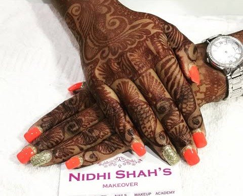 Orange and gold glitter nails with bridal mehendi